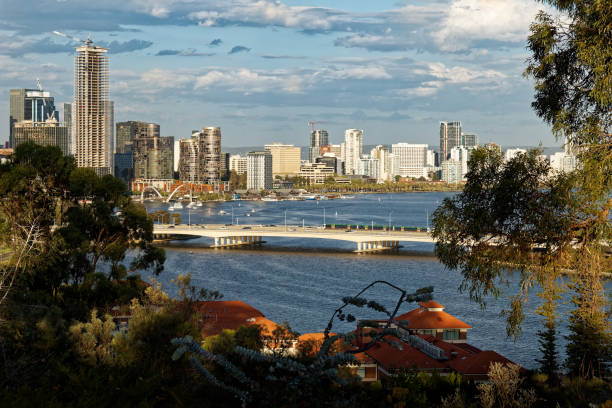landscape with the skyscrapers, parks and bay with the bridge during sunset or sunrise. Clouds on the dramatic blue sky.