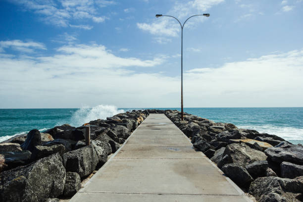 Samll wave hitting a rocky jetty