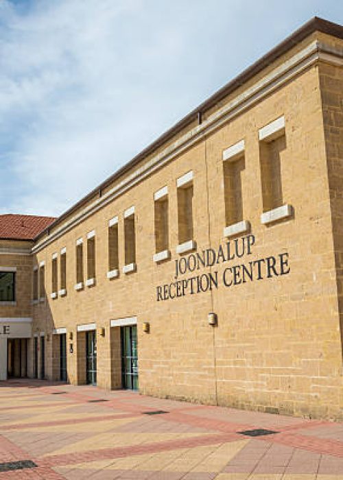 Beautiful stone architecture of a civic and reception centre exterior with clear skies. Perfect for events, gatherings, and municipal services.