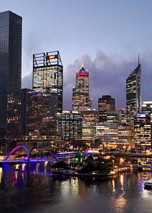 Elizabeth Quay Bridge in Perth captured at night with glowing lights from above.