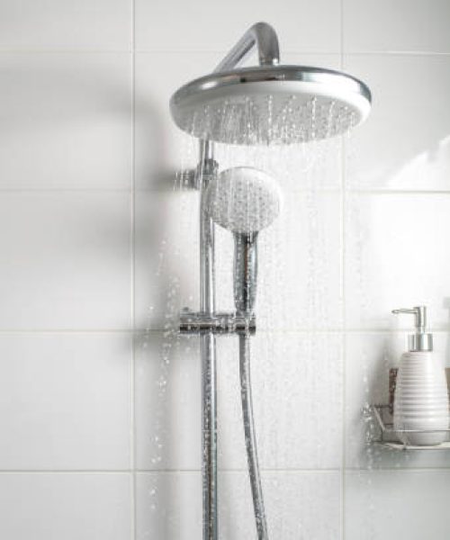 Jets of clean water flowing in the shower cabin. Selective focus.
