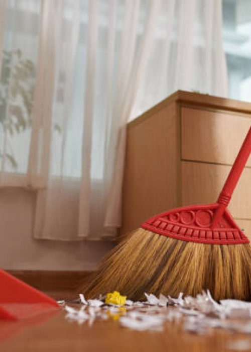 Closeup image of worker wiping dirty floor in house of client